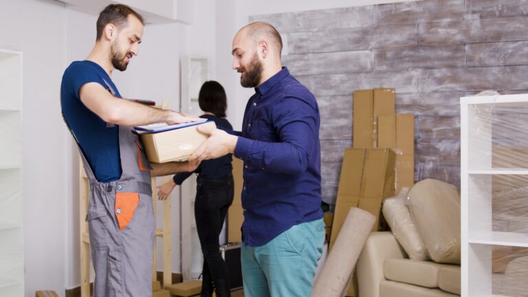Handyman helping a young couple move into their new Toronto condo with boxes